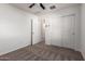A cozy bedroom with carpet, a ceiling fan, and closet with sliding doors at 8253 W Illini St, Phoenix, AZ 85043