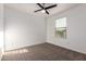 Empty bedroom with carpet and ceiling fan plus a window with a neighborhood view at 8253 W Illini St, Phoenix, AZ 85043