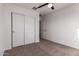 Bedroom featuring neutral carpet, ceiling fan, and large closet space at 8253 W Illini St, Phoenix, AZ 85043