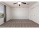 Bedroom featuring neutral carpet, ceiling fan, and large closet space at 8253 W Illini St, Phoenix, AZ 85043