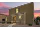 Inviting two-story home featuring a neutral stucco facade and tile roof, complemented by a gravel yard and charming entryway at 8253 W Illini St, Phoenix, AZ 85043