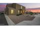Inviting two-story home featuring a neutral stucco facade and tile roof, complemented by a gravel yard and charming entryway at 8253 W Illini St, Phoenix, AZ 85043