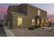 Inviting two-story home featuring a neutral stucco facade and tile roof, complemented by a gravel yard and charming entryway at 8253 W Illini St, Phoenix, AZ 85043