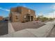 Inviting two-story home featuring a neutral stucco facade and tile roof, complemented by a gravel yard and charming entryway at 8253 W Illini St, Phoenix, AZ 85043