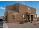 Inviting two-story home featuring a neutral stucco facade and tile roof, complemented by a gravel yard and charming entryway at 8253 W Illini St, Phoenix, AZ 85043