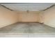 Open two car garage interior with concrete flooring and lighting at 8253 W Illini St, Phoenix, AZ 85043