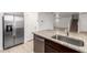 Modern kitchen with stainless steel appliances, granite counters, and light wood flooring at 8253 W Illini St, Phoenix, AZ 85043