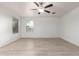 Neutral living room with wood-look floors, bright natural light, and recessed lighting at 8253 W Illini St, Phoenix, AZ 85043
