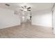 Open-concept living area featuring wood-look floors and recessed lighting with an open flow to kitchen at 8253 W Illini St, Phoenix, AZ 85043