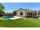 Backyard features a pool, artificial grass, and covered patio at 840 E Baylor Ln, Chandler, AZ 85225