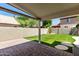 Covered patio overlooking the backyard's lush artificial grass and block perimeter wall at 840 E Baylor Ln, Chandler, AZ 85225
