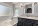 Bathroom featuring a soaking tub, vanity, and large windows for natural lighting at 840 E Baylor Ln, Chandler, AZ 85225
