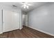 Bedroom with wood floors, a ceiling fan, and a closet with sliding doors at 840 E Baylor Ln, Chandler, AZ 85225