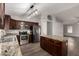 Features an eat-in island, stainless steel appliances, and dark cabinetry at 840 E Baylor Ln, Chandler, AZ 85225