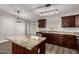 This kitchen features a granite island, stainless steel appliances and hardwood floors at 840 E Baylor Ln, Chandler, AZ 85225