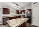 Well-lit kitchen features an eat-in island with granite countertops and stainless appliances at 840 E Baylor Ln, Chandler, AZ 85225