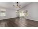 Bright living room featuring wood floors, neutral paint, and a ceiling fan at 840 E Baylor Ln, Chandler, AZ 85225