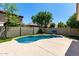 Backyard pool with lush green turf, basketball hoop, and privacy wall, perfect for outdoor relaxation and recreation at 840 E Baylor Ln, Chandler, AZ 85225