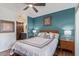 Bedroom with a ceiling fan, wood floors, and a view into the en-suite bathroom at 9450 E Becker Ln # 1046, Scottsdale, AZ 85260