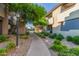 Apartment complex with a tree-lined sidewalk and grassy landscaped areas at 9450 E Becker Ln # 1046, Scottsdale, AZ 85260