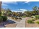 Community pool area featuring palm trees, lounge chairs, and an American flag on a pole at 9450 E Becker Ln # 1046, Scottsdale, AZ 85260