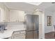 Kitchen featuring stainless steel refrigerator, white cabinets and a countertop at 9450 E Becker Ln # 1046, Scottsdale, AZ 85260