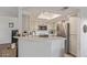 Bright kitchen with stainless steel appliances, white cabinetry, and a breakfast bar at 9450 E Becker Ln # 1046, Scottsdale, AZ 85260
