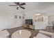 Cozy living room featuring a ceiling fan, wood floors, and a pass-through to the kitchen at 9450 E Becker Ln # 1046, Scottsdale, AZ 85260