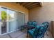 Outdoor patio with decorative metal furniture and a sliding glass door, offering a relaxing space at 9450 E Becker Ln # 1046, Scottsdale, AZ 85260