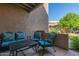 Cozy patio with stylish blue cushioned seating and an ornate metal table at 9450 E Becker Ln # 1046, Scottsdale, AZ 85260
