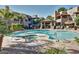 Inviting community pool with a spa, surrounded by lush landscaping and comfortable lounge seating at 9450 E Becker Ln # 1046, Scottsdale, AZ 85260