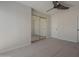 Spacious bedroom with carpet, ceiling fan, and mirrored closet at 10101 N 91St Ave # 111, Peoria, AZ 85345