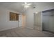 Carpeted bedroom with closet, ceiling fan, and window with wood accent wall at 10101 N 91St Ave # 111, Peoria, AZ 85345