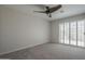 Neutral bedroom featuring plantation shutters and a ceiling fan at 10101 N 91St Ave # 111, Peoria, AZ 85345