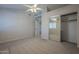 A carpeted bedroom showcasing a sliding closet and an entrance into another room at 10101 N 91St Ave # 111, Peoria, AZ 85345