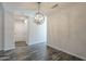Bright dining room featuring new gray tone wood flooring and modern chandelier lighting at 10101 N 91St Ave # 111, Peoria, AZ 85345