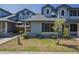 Attractive townhouse with blue siding,dormer windows, and lush green lawn at 10101 N 91St Ave # 111, Peoria, AZ 85345