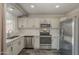 Bright kitchen with gray tone wood flooring, stainless appliances, and modern countertops at 10101 N 91St Ave # 111, Peoria, AZ 85345