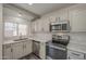 Modern kitchen featuring stainless steel appliances, modern countertops, and gray tone wood flooring at 10101 N 91St Ave # 111, Peoria, AZ 85345