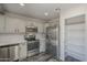 Modern kitchen with stainless steel appliances, white cabinets, and a walk-in pantry at 10101 N 91St Ave # 111, Peoria, AZ 85345