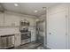 Spacious kitchen with modern stainless steel appliances and gray tone wood flooring at 10101 N 91St Ave # 111, Peoria, AZ 85345