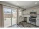 Bright kitchen featuring stainless steel appliances, modern countertops, and gray tone wood flooring at 10101 N 91St Ave # 111, Peoria, AZ 85345
