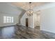 Open living room with gray tone wood flooring and a decorative wooden barn door at 10101 N 91St Ave # 111, Peoria, AZ 85345