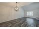 Open living room with gray tone wood flooring and a bright window at 10101 N 91St Ave # 111, Peoria, AZ 85345