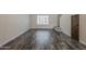 Living room showcasing gray tone wood flooring and a bright window at 10101 N 91St Ave # 111, Peoria, AZ 85345