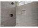 Close-up of the updated walk-in shower with sleek tile and recessed soap nook at 10101 N 91St Ave # 111, Peoria, AZ 85345