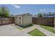 Backyard features useful matching storage shed and artificial grass at 10101 N 91St Ave # 111, Peoria, AZ 85345