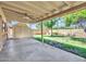 Spacious covered patio area looking out to the grassy backyard with block wall at 13810 N 39Th Ave, Phoenix, AZ 85053