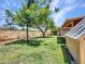 Spacious backyard featuring mature trees, a block fence, and a covered patio, perfect for outdoor entertaining at 13810 N 39Th Ave, Phoenix, AZ 85053