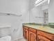 Bathroom featuring wood cabinetry, solid surface sink, and vanity mirror at 13810 N 39Th Ave, Phoenix, AZ 85053